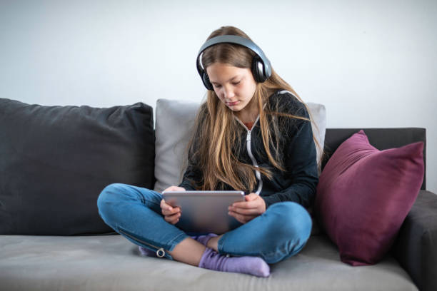 istock A girl watching TV at home 1321868593
