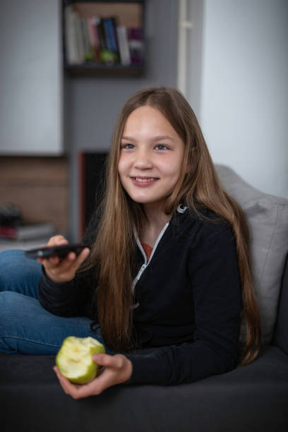 istock A girl watching TV at home 1321869040