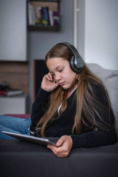istock A girl watching TV at home 1321869120