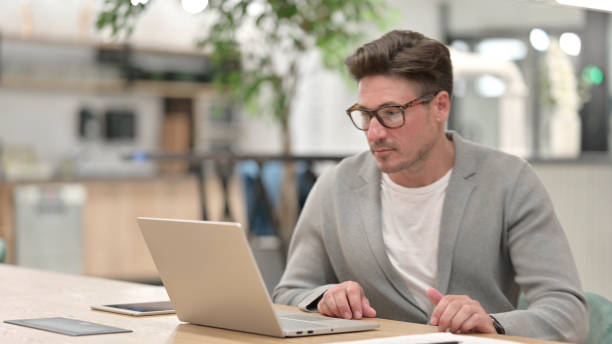 istock Middle Aged Man Leaving Laptop and Going Away 1321870334