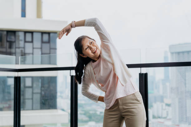 istock Happy senior woman with smart watch doing relaxation exercise 1321871797
