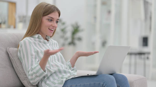 istock Young Woman Talking For Video Chat on Laptop 1321873228
