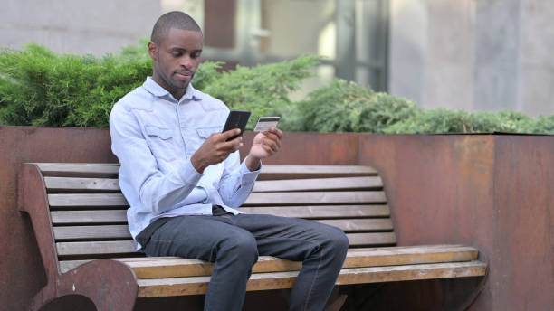 istock African Man making Successful Online Payment on Smartphone 1321873274