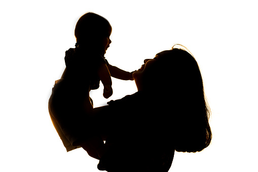 silhouette asian young mother carrying her baby