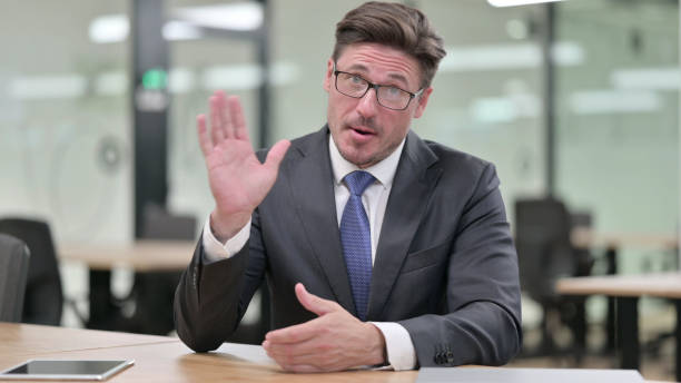 istock Positive Middle Aged Businessman doing Video Chat in Office 1321876378