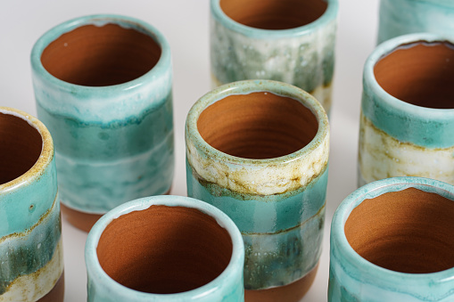 Turquoise ceramic mugs background. Pottery as hobby