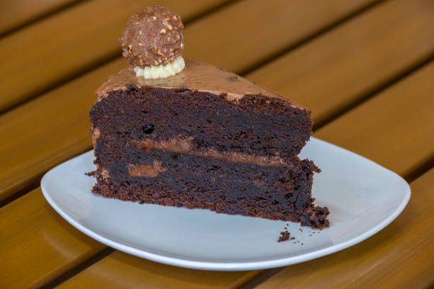 istock Slice of chocolate cake on white plate 1321879298