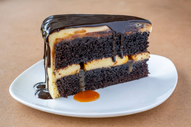 istock Slice of caramel chocolate cheese cake on white plate 1321879528