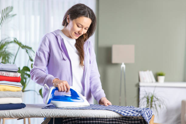 istock Young woman ironing at home 1321879969
