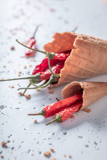 istock Chilli peppers on ice cream cone as strange flavors. 1321882286