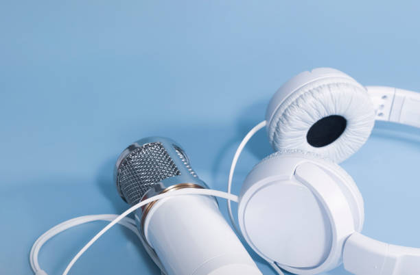 istock Headphones and microphone for sound recording on a blue background with space for text 1321888200