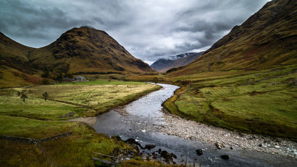 AERIAL: Glen Etive, Scottish Highlands Glen Etive, an idyllic small valley in the Scottish Highlands near Glencoe, Scotland, United Kingdom. Etive River in the foreground. lochaber stock pictures, royalty-free photos & images