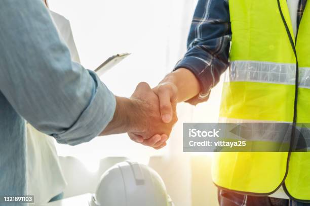 Contractor Construction Worker Team Hands Shaking After Plan Project Contract On Workplace Desk In Meeting Room Office At Construction Site Contractor Engineering Partnership Construction Concept Stock Photo - Download Image Now