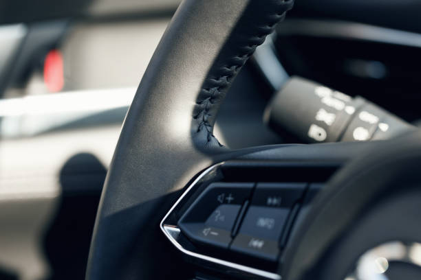 istock Multimedia leather steering wheel in a modern expensive car. Black leather steering wheel. Modern car interior details. Selective focus. Part of stitched leather black leather car interior. Macro shot 1321894298
