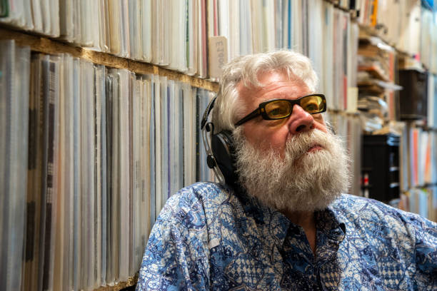 istock Record collector with headset on, in front of his collection 1321895191