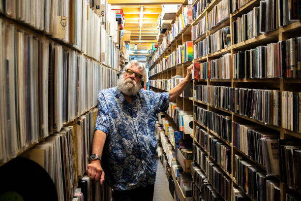 istock Record collector with headset on, in front of his collection 1321895223