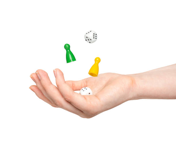 istock figures for board game and dice in hand isolated on white background. levitation 1321897950