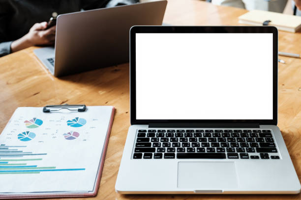istock White blank screen tablet on modern working desk with business working on background. 1321899639