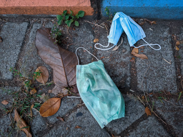 istock used medical masks on the ground 1321899857