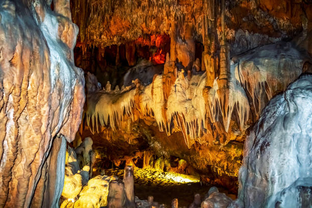 istock Stalactites and stalagmites illuminated with yellow-orange light inside Damlatas cave in Alanya (Turkey), close-up 1321901287
