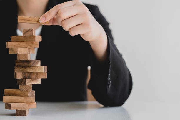 istock plan and strategy in business protect with balance wooden stack with hand control risk shape. 1321901309