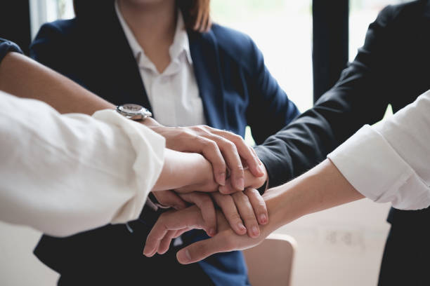 istock As they laugh and celebrate their performance, the business team makes a handshake motion 1321901524