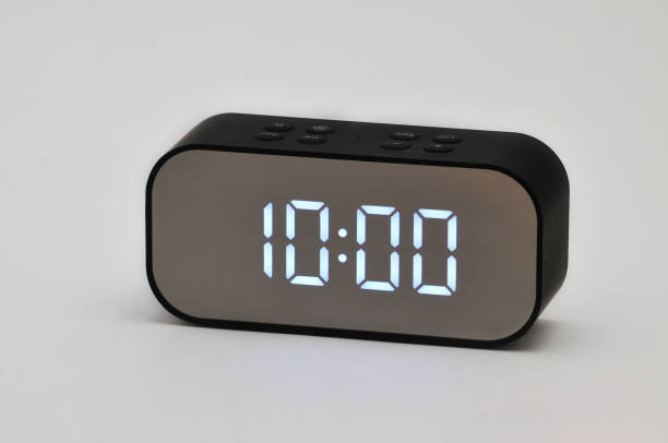 istock Electronic clock with digital indication of time and date on a white background 1321902911