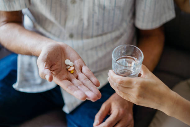 istock Senior asian man taking medicines at home 1321906130