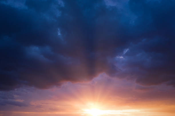 istock Cancer blue stormy sky with sun rays. 1321907134