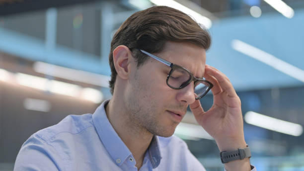 istock Close up of Young Man having Headache 1321909401