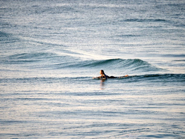 Sunrise Surfing - Brunswick Heads, NSW Horizontal seascape photo of surfers catching waves at popular travel destination, Brunswick Heads, near Byron Bay, NSW brunswick heads nsw stock pictures, royalty-free photos & images