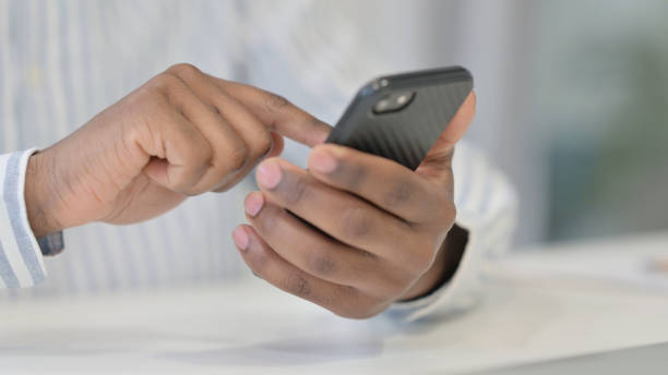 istock Close Up of African Man using Smartphone, Mobile 1321918937