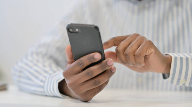 istock Close Up of African Man using Smartphone, Mobile 1321919013