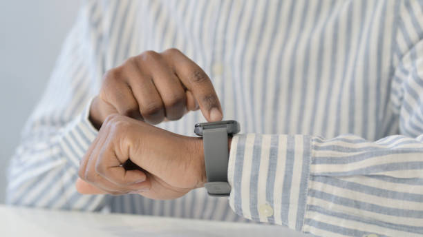 istock Close Up of African Hands using Smart Watch 1321919387