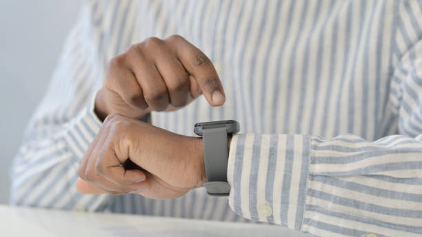 istock Hands Close Up of African Man using Smart Watch 1321919496