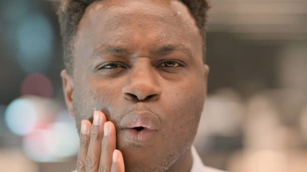 istock Close up of African Man having Toothache 1321919509