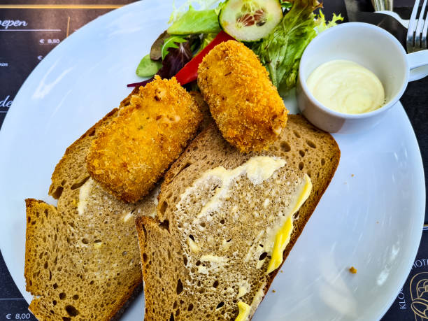istock Blue plate with two croquettes on brown bread 1321919802