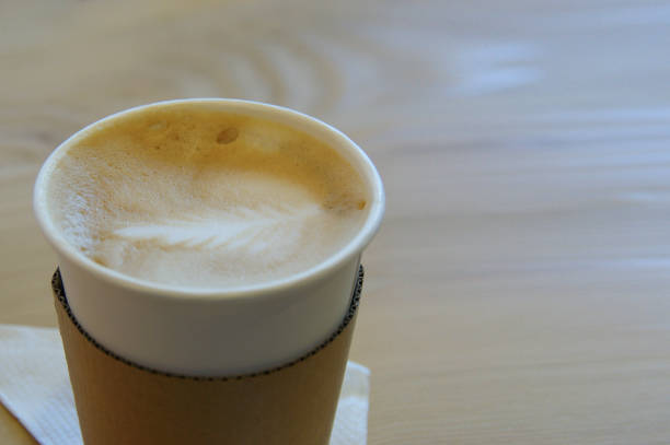 istock cappuccino in paper cup. cappuccino with a pattern on foam 1321919852