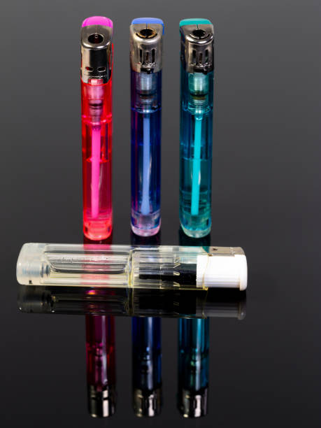 istock Four gas lighters in different colours on a gray reflecting background 1321925075