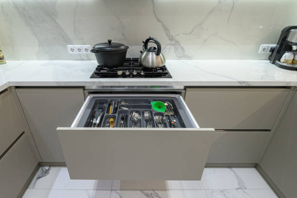 istock Open drawer with cutlery at modern white woden kitchen in classic style 1321926319