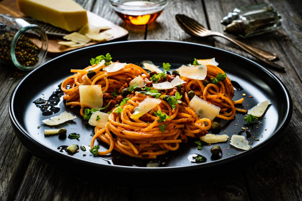istock Spaghetti bolognese - pasta with minced pork and tomato sauce on black table 1321926496