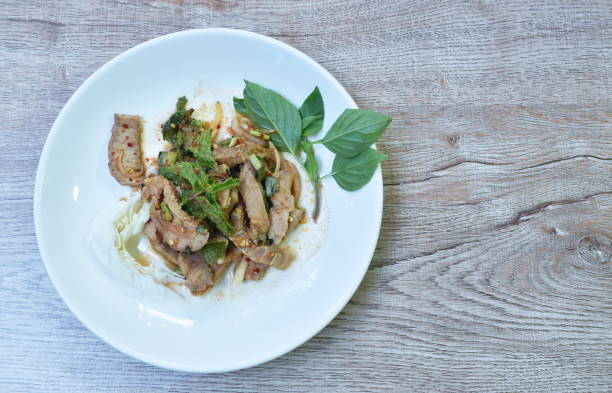 istock spicy roasted pork Thai salad eat with fresh basil leaf and cabbage 1321928189