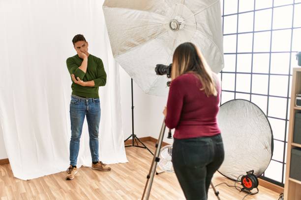istock Young man at photography studio thinking looking tired and bored with depression problems with crossed arms. 1321929364