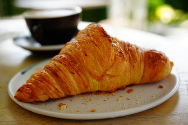 istock Fresh baked croissants and coffee 1321929802