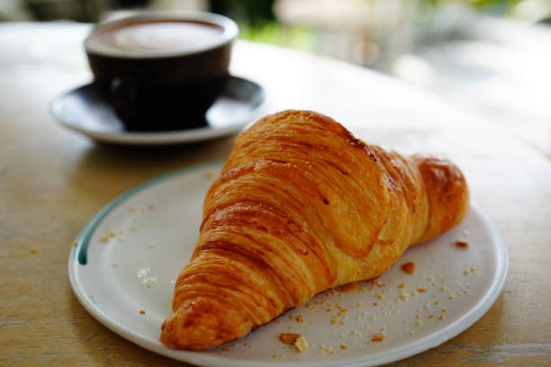 istock Fresh baked croissants and coffee 1321929812