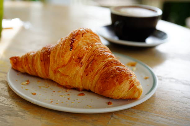 istock Fresh baked croissants and coffee 1321929824