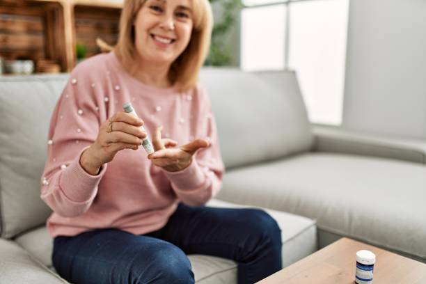 istock Middle age diabetic woman measuiring glucose using glucometer at home. 1321931011