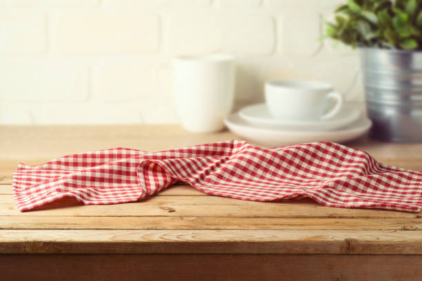istock Empty wooden table with tablecloth over kitchen shelf background.  Interior mock up for design and product display. 1321931165
