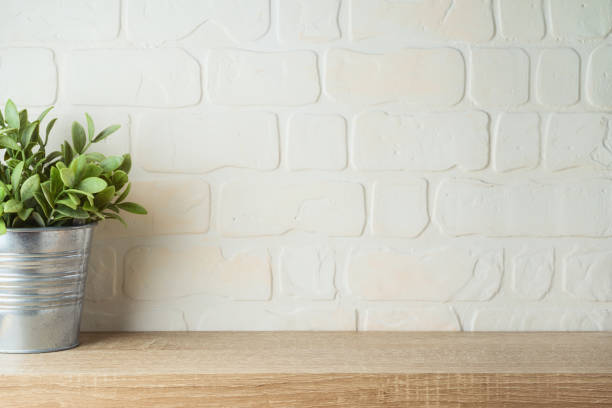 istock Empty wooden shelf with plant over brick wall interior. Kitchen mock up for design 1321931175