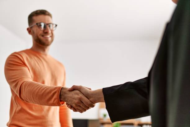 istock Two caucasian business executives shaking hands at the office. 1321931428
